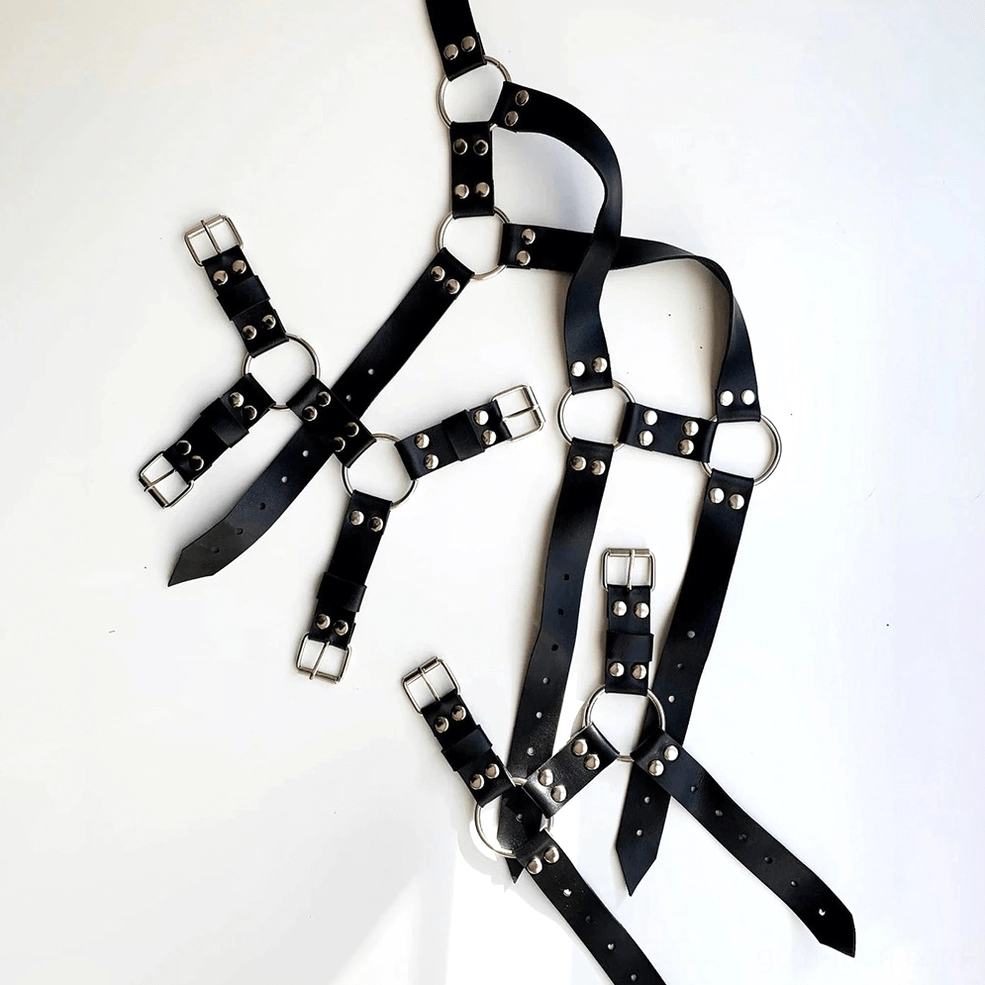Premium black PU leather gothic harness with polished metal D-rings and industrial hardware details