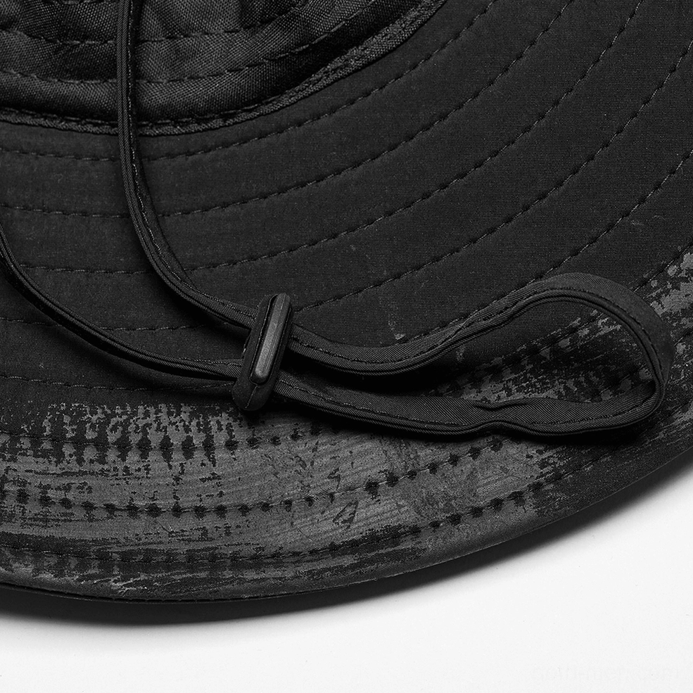 Close-up side view of black gothic hat brim showing quilted stitching, adjustable chin cord, and distressed finish