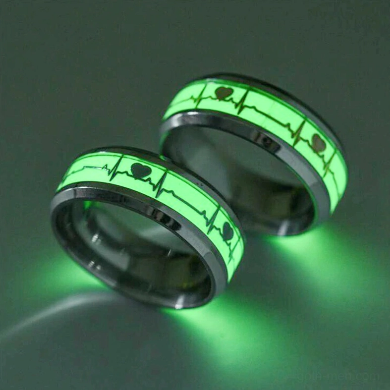 Couple's luminous stainless steel ECG rings with green glowing heartbeat, low angle dark background