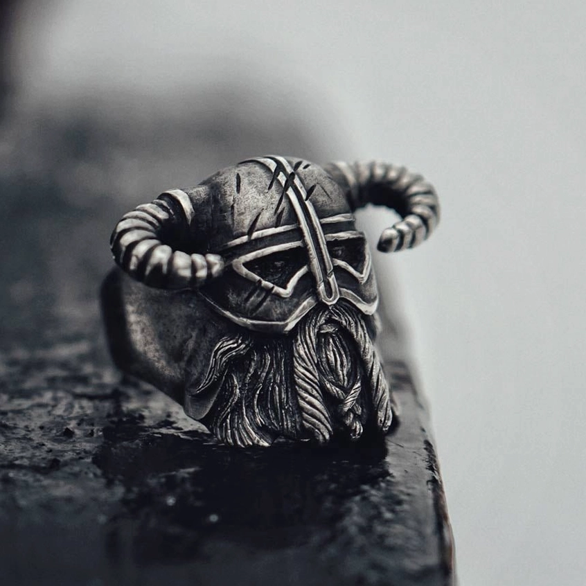 Gothic horned helmet ring close-up side profile - distressed dark metal finish with fine texture details