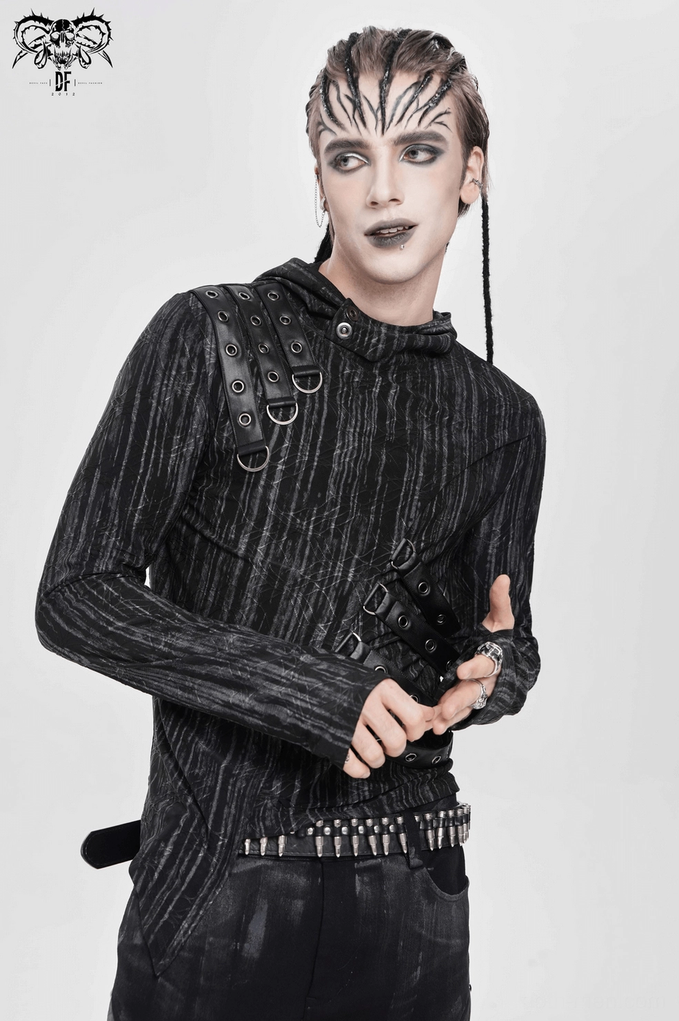Close-up of metal grommet and leather strap attachment on gothic cyberpunk hooded top