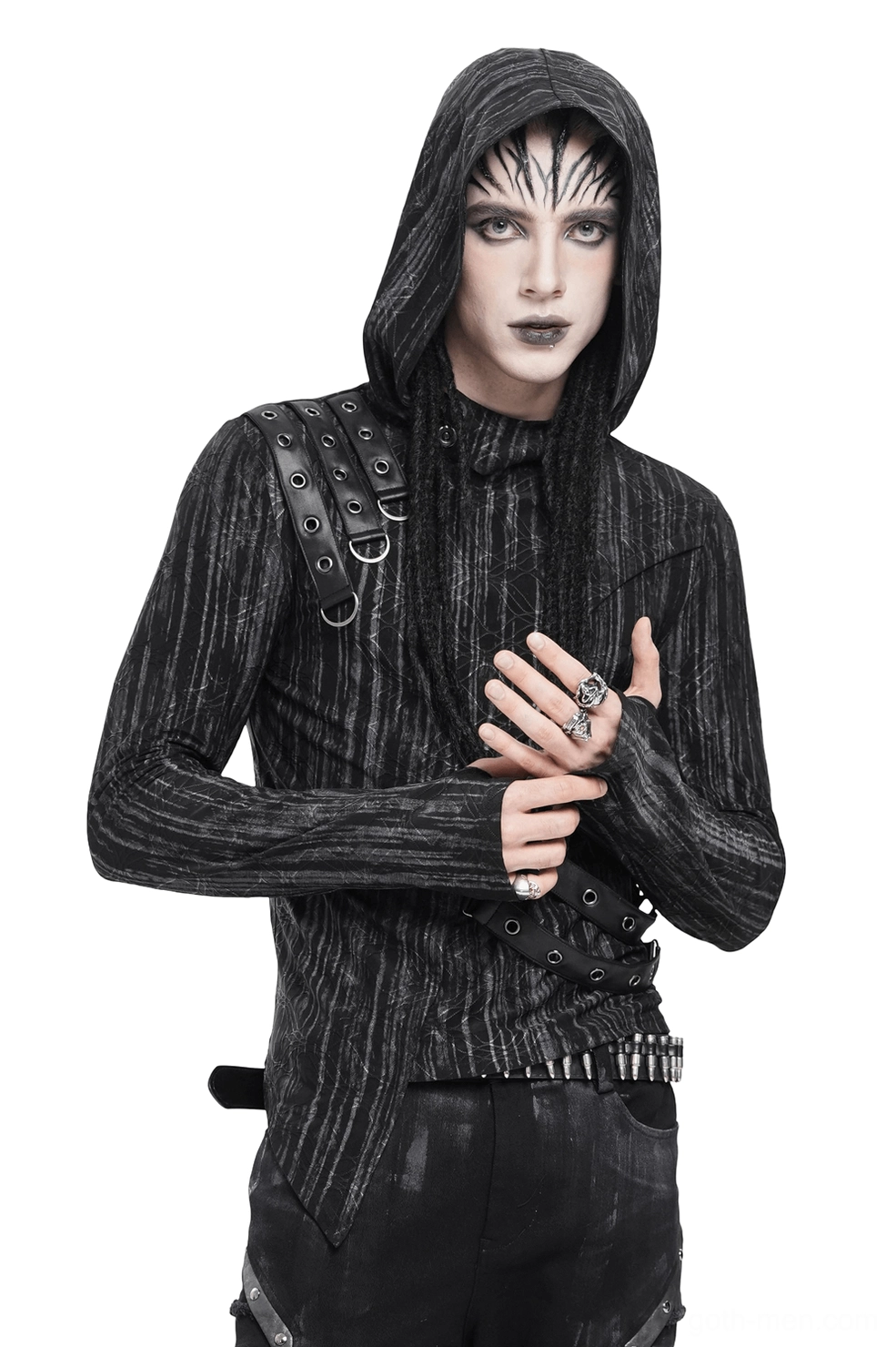 Industrial gothic hooded top with asymmetric hem and metal eyelet straps, front three-quarter view on male model