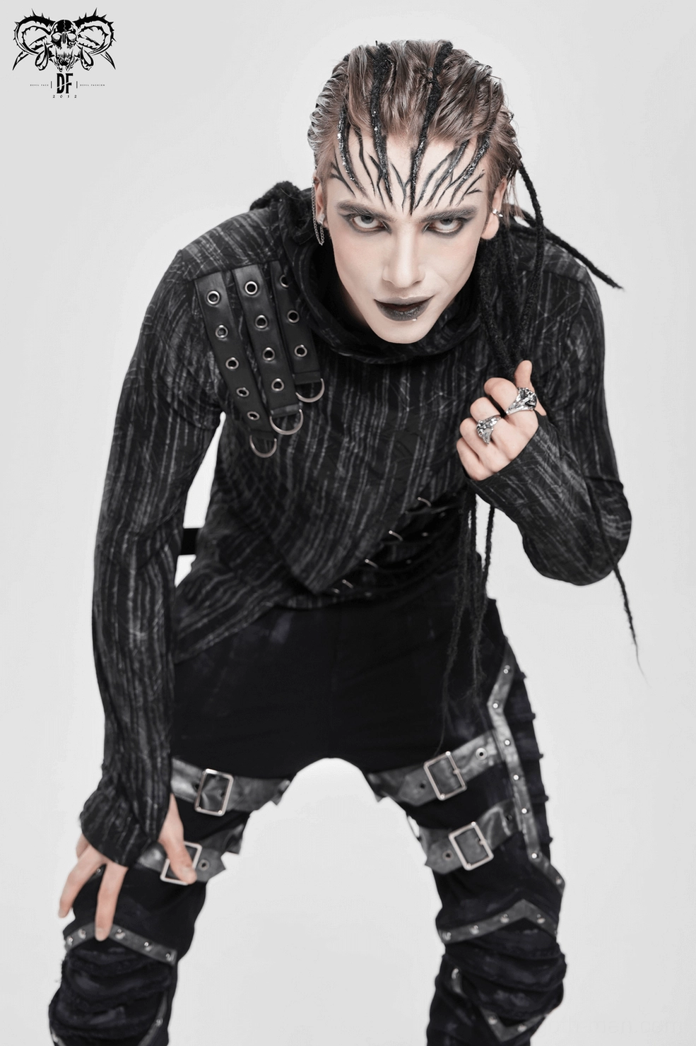 Detail shot of striped knit weave and metal hardware on industrial gothic hoodie