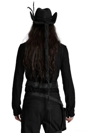 Black gothic cowboy hat rear view with long decorative tassel, worn by male model in dark goth outfit showing back details