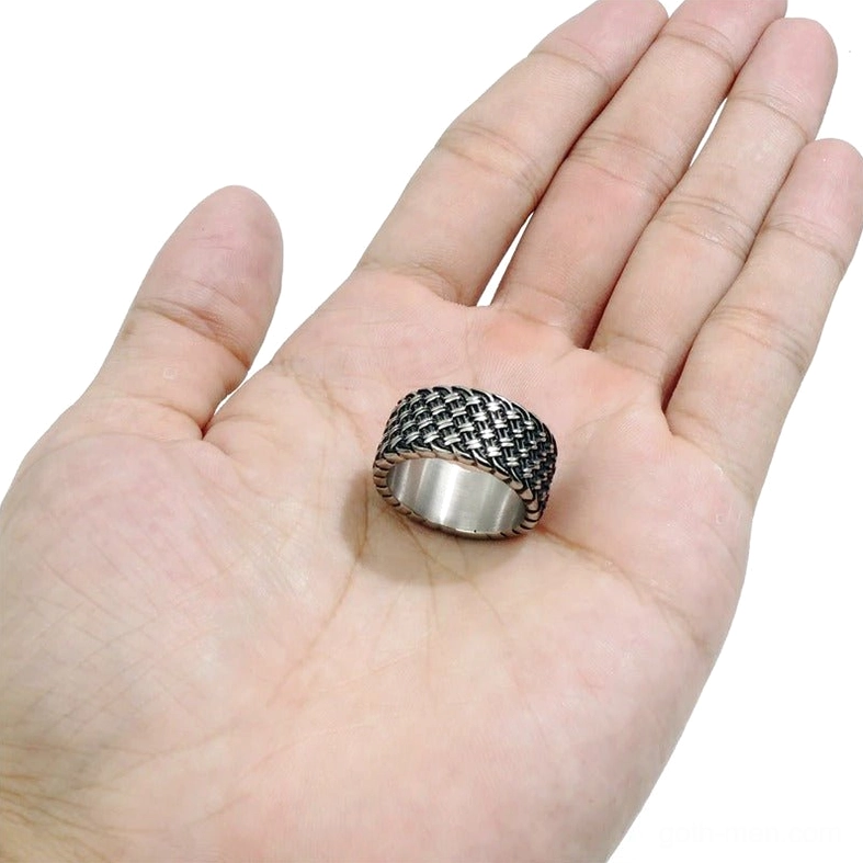 Gothic interwoven stainless steel ring placed on palm showing braided vintage design and scale