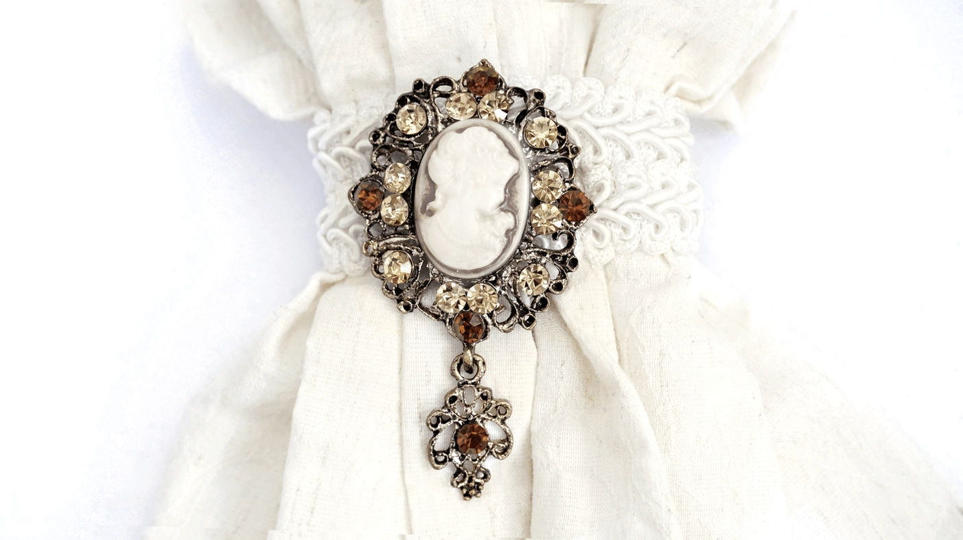 Front Close-Up of Gothic White Lace Jabot - Oval Cameo Pendant with Rhinestone Decor
