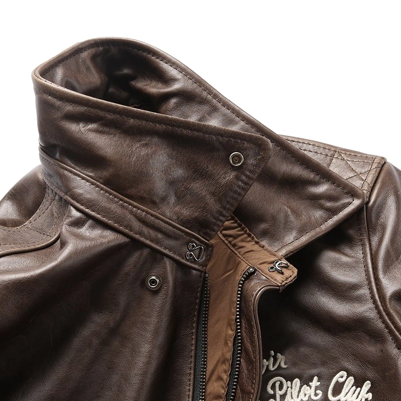 Close-up detail of gothic leather jacket collar showing snap buttons and zipper placket construction