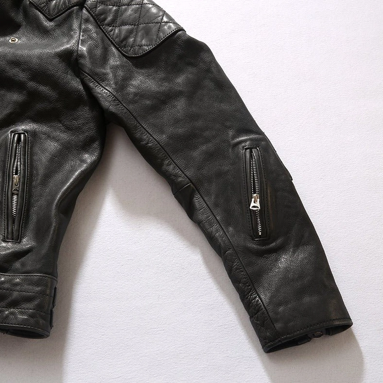 Black leather gothic jacket detail view of asymmetrical dual zippers and metal zipper construction
