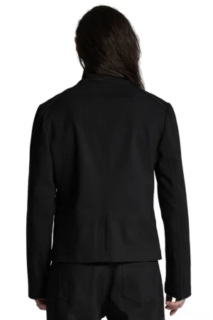 Deconstructed gothic jacket front detail showing stand collar, buckle fasteners and zippered pocket