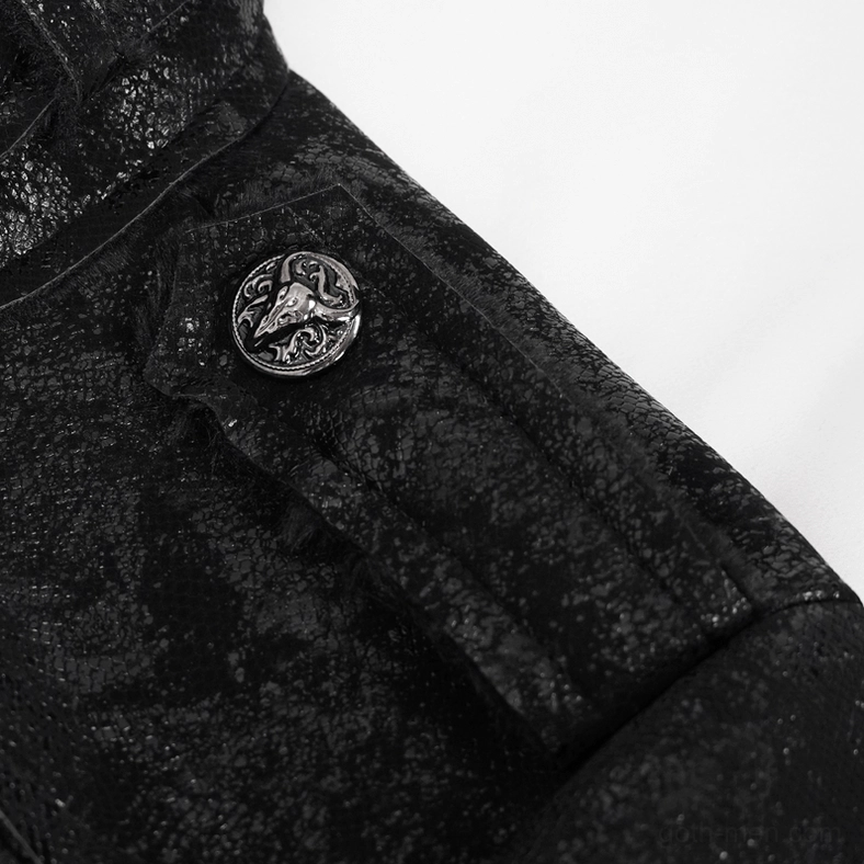 Close-up of embossed metal emblem on structured shoulder seam of gothic jacket