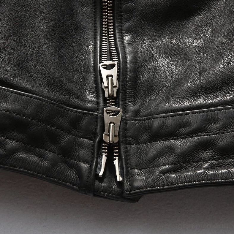 Black leather gothic jacket close-up showing dual metal zipper pulls and textured premium cowhide texture