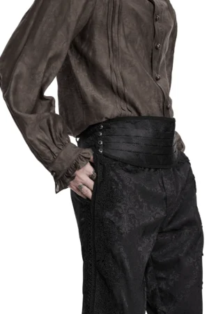 Side angle view of black jacquard gothic waist belt showing paisley texture, metal snap fasteners, and pleated structure on male model