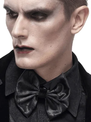 Profile view of gothic bow tie on model wearing formal black shirt, side portrait with goth makeup styling