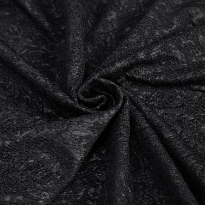 Detailed texture shot of black gothic jacquard fabric pattern showing vintage weave and material quality