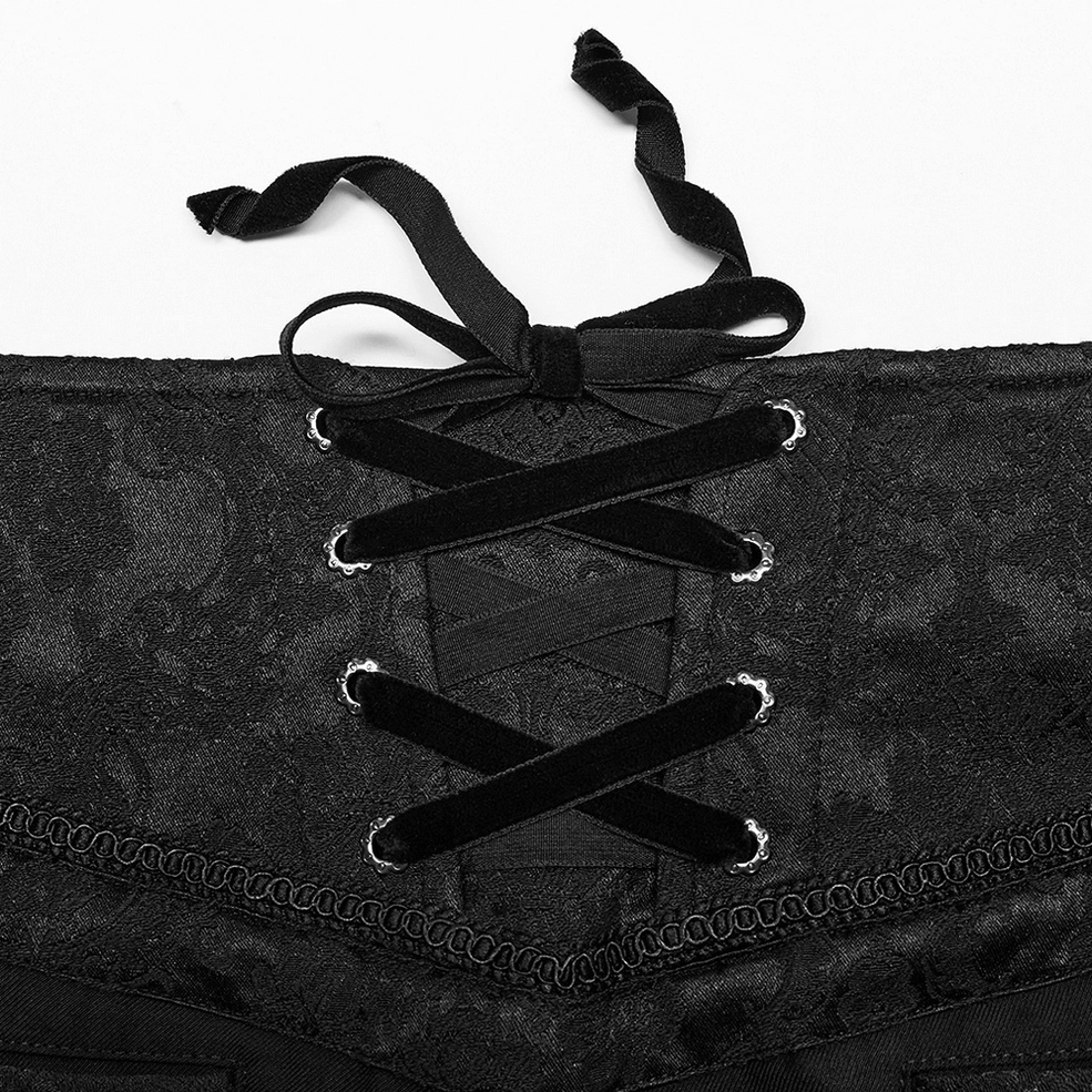 Gothic jacquard trousers waist close-up, velvet ribbon lacing, metal eyelets and jacquard fabric texture
