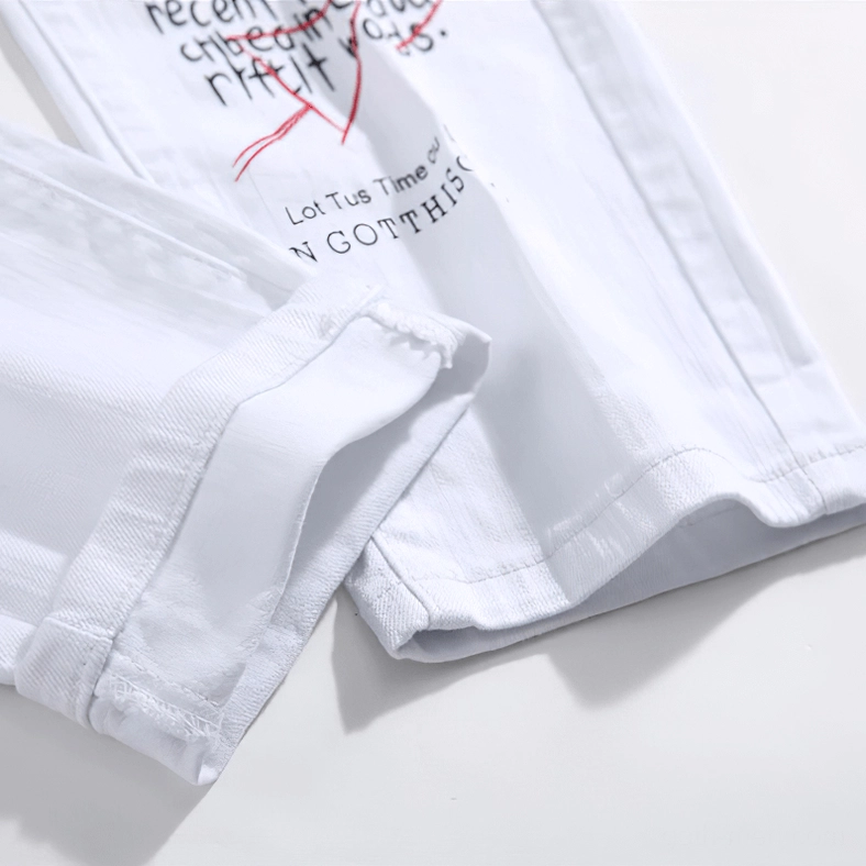 Gothic graffiti jeans side seam detail showing embroidery accents and ripped holes
