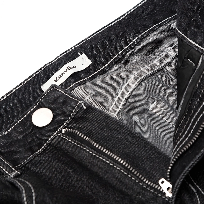Gothic jeans waist detail view, denim fabric texture with branded metal button fly closure