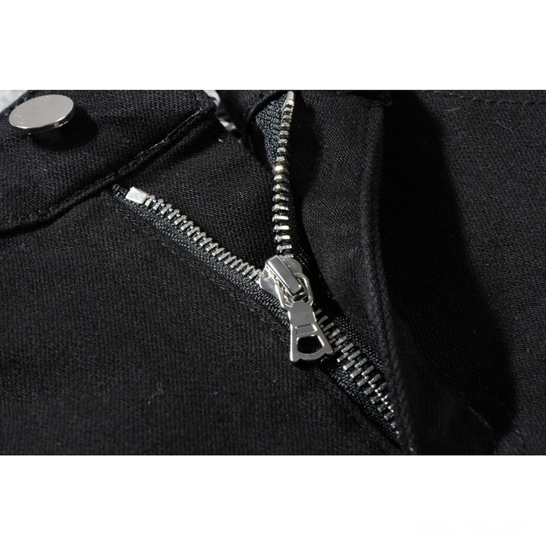 Metal zipper fly and button hardware detail on black gothic slim fit distressed jeans