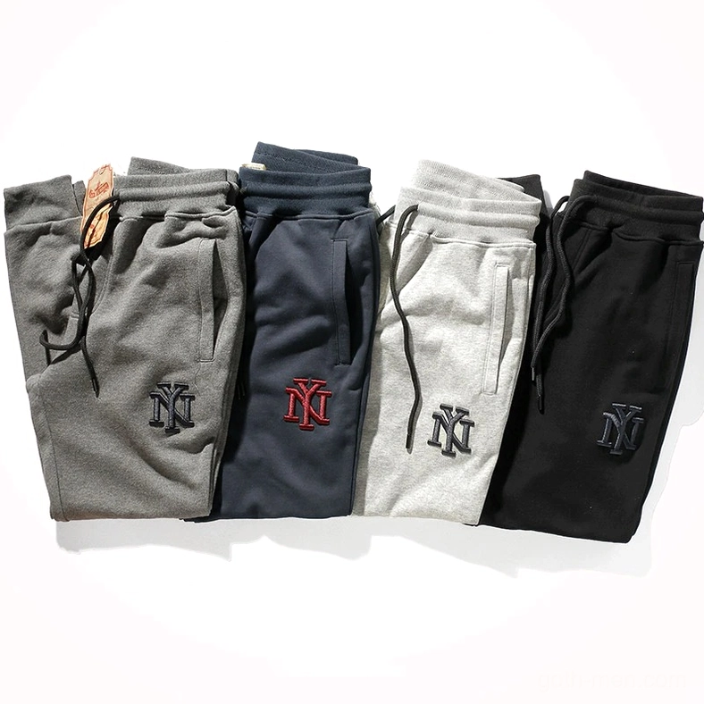 Top-down view of gothic harem joggers collection, showing all four color variants with NY logos