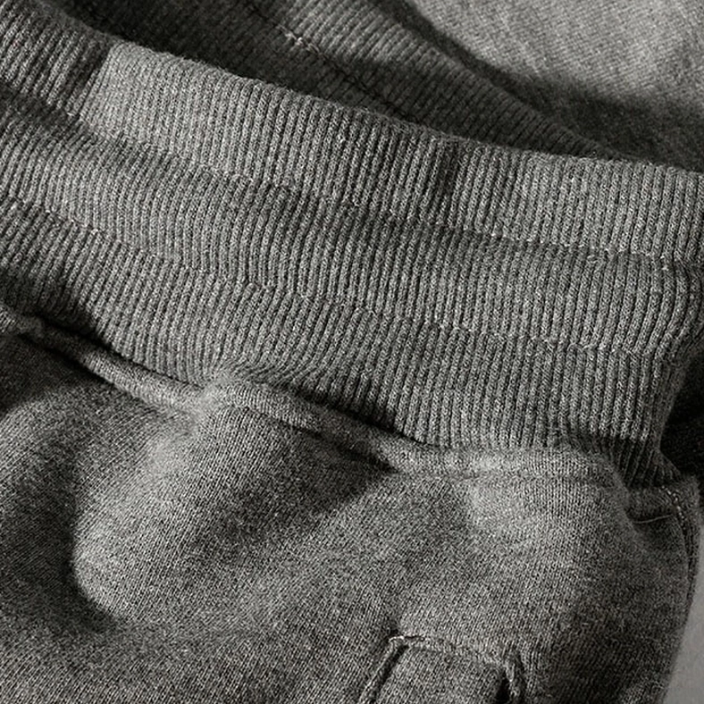 Close-up of terry fleece fabric texture and ribbed ankle cuff on gothic harem joggers