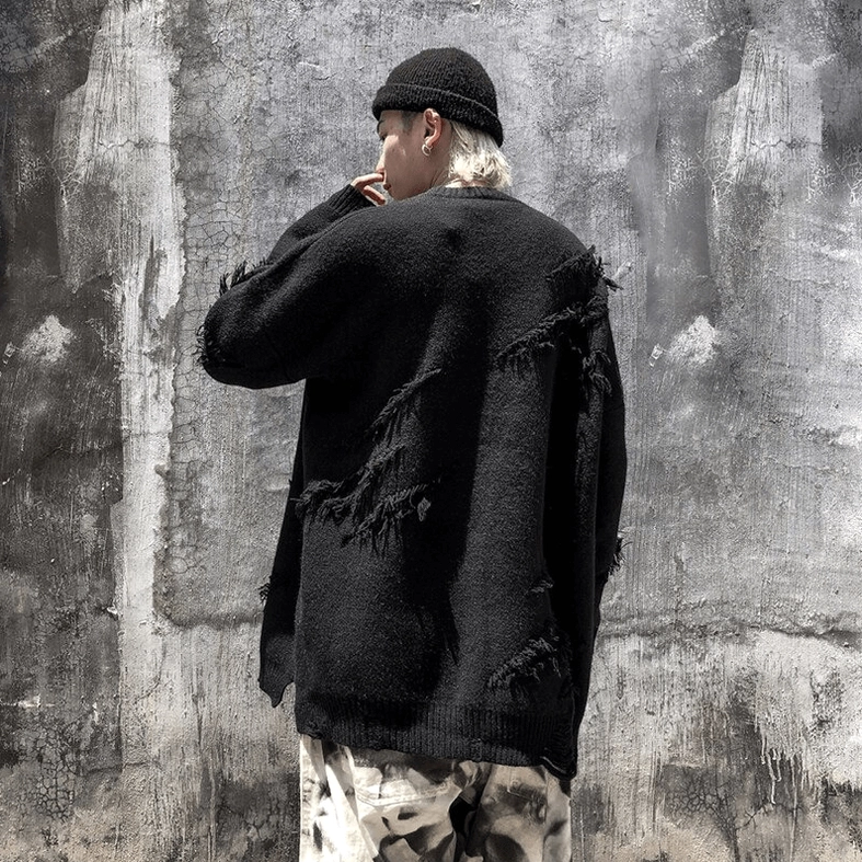 Drop shoulder fit and oversized silhouette of black distressed gothic jumper side angle
