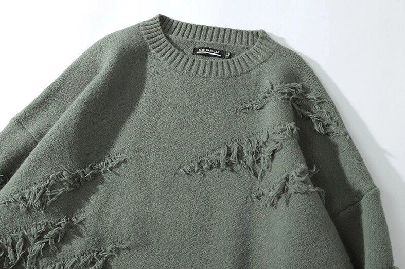 Layering technique with distressed gothic jumper over white button-down shirt