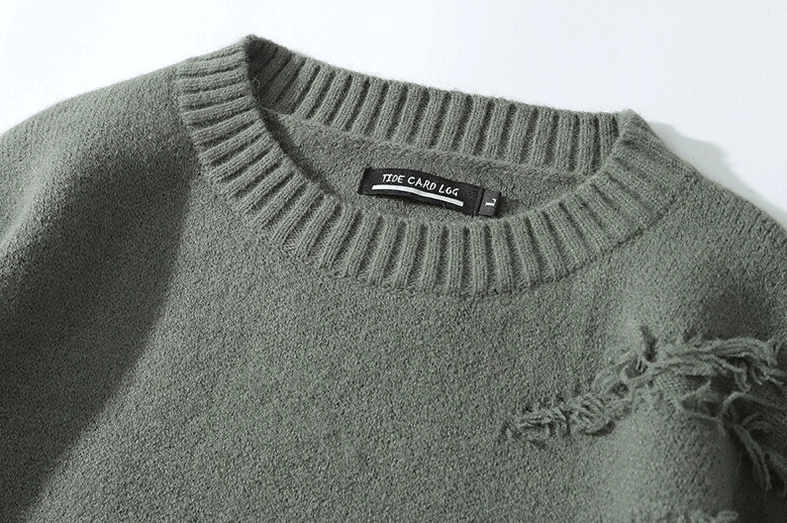 Close-up crew neck collar detail of distressed gothic knit jumper with ribbed trim