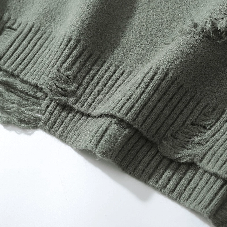 Hem detail of oversized gothic knit jumper showing ribbed edge and slight fraying