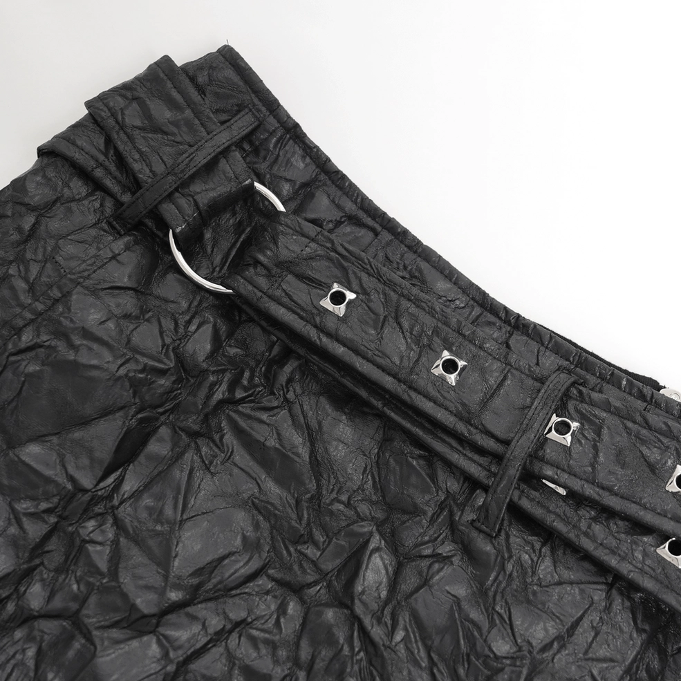 Black crinkled synthetic leather gothic kilt detail showing buckle mechanism and textured leather surface