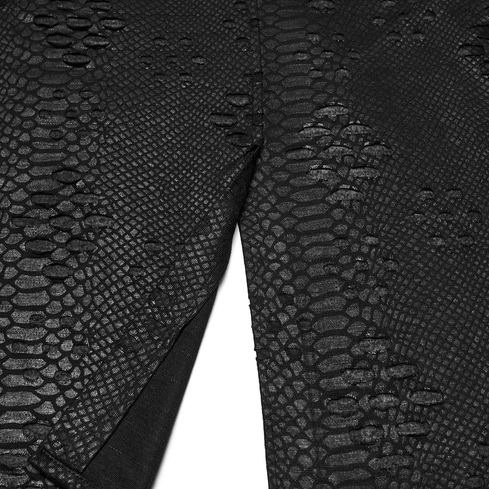 Fabric texture close-up of gothic kilt showing tattered cut-out knit sections and snake print faux leather panels