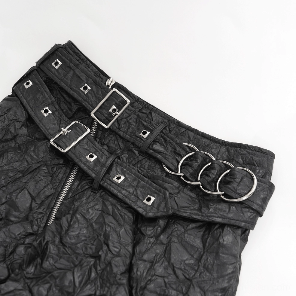 Black crinkled leather gothic kilt close-up showing metal buckles and rings on waist belt and synthetic leather texture