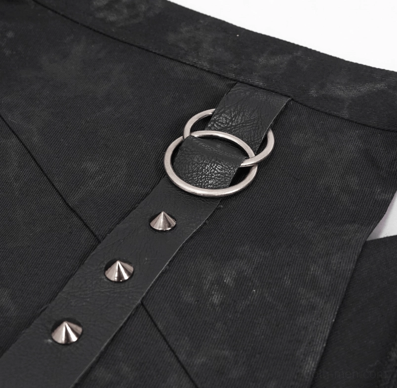 Close-up of silver pyramid studs, dual metal D-rings, and black leather strap accessory for gothic kilt