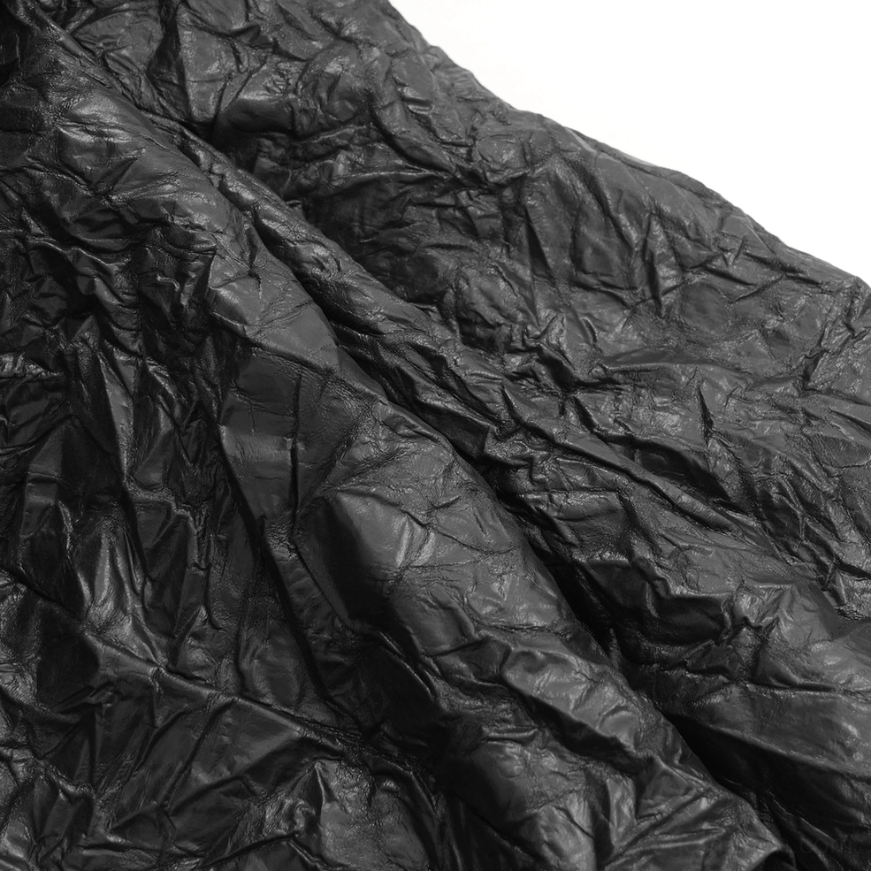 Black crinkled leather gothic kilt side angle view displaying metal ring buckles and functional cargo pocket flap