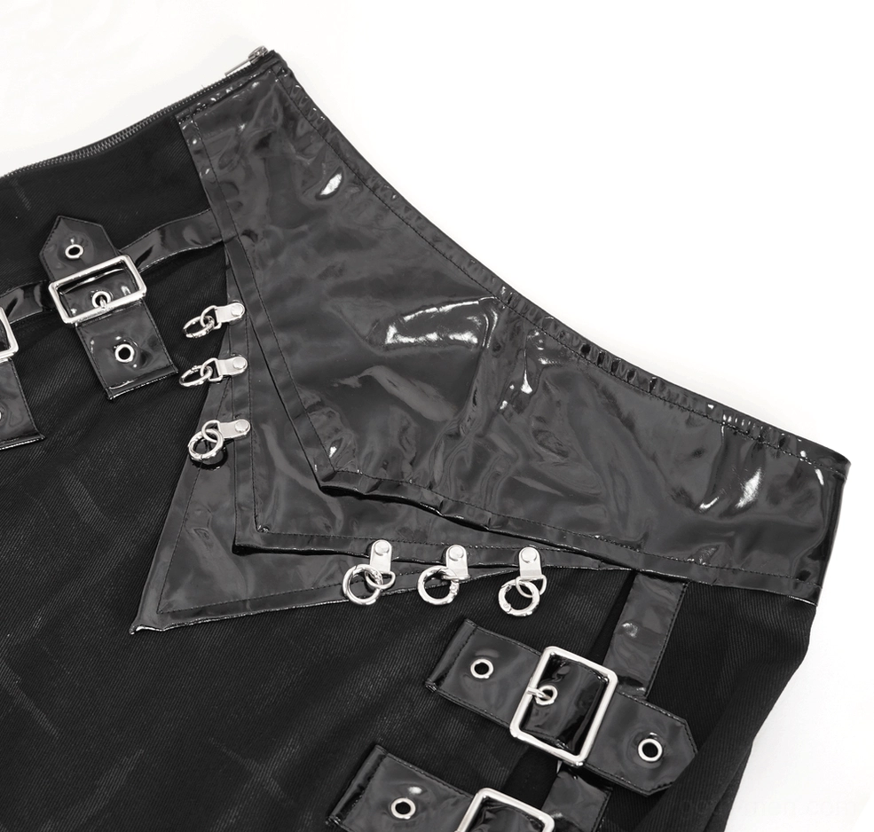 Close-up of gothic kilt waist hardware showing silver D-rings, buckles and glossy patent leather panels