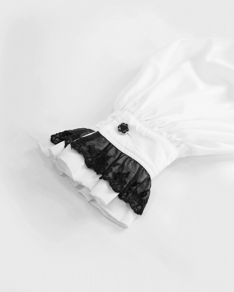 Close-up detail of black ruffled lace cuff on white gothic men's shirt - texture and button fastener