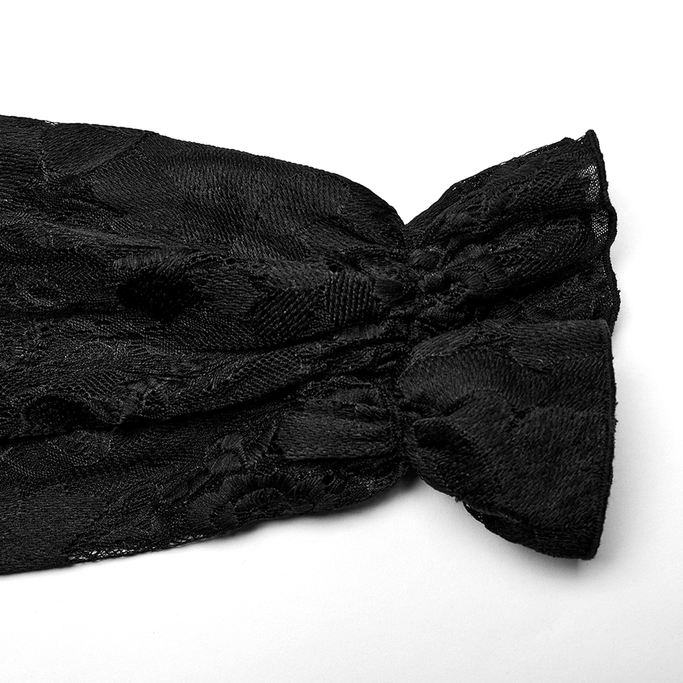 Close-up detail of black lace gothic shirt cuff showing gathered ruffled lace texture and embroidered pattern