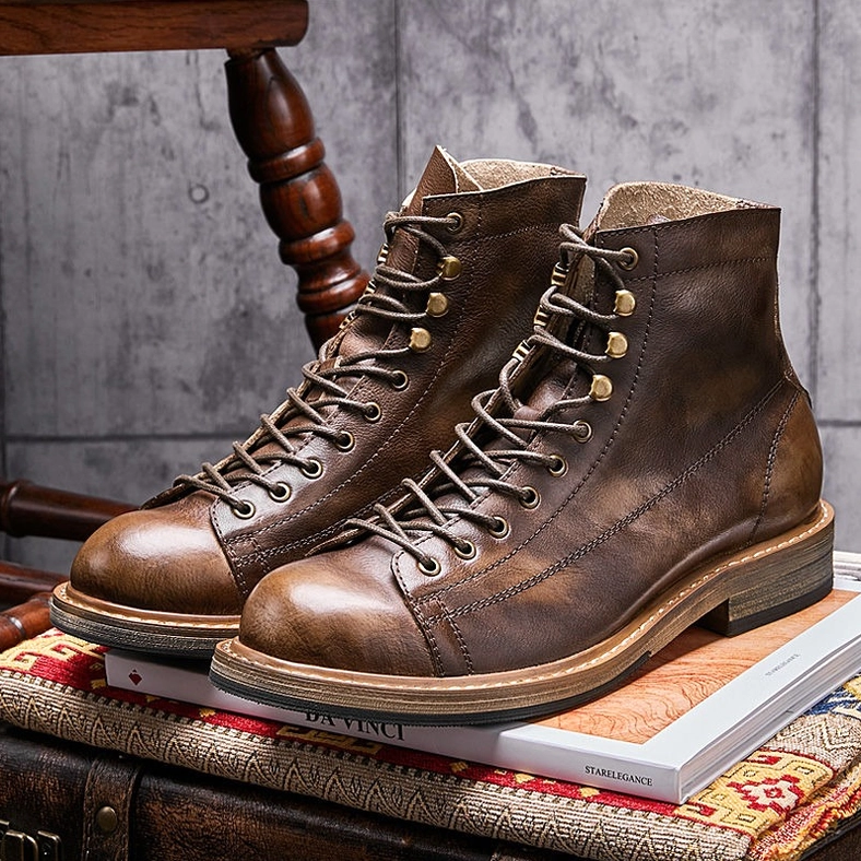 Men's gothic lace-up ankle boots with brass fixtures and pleated design elements, styling showcase view