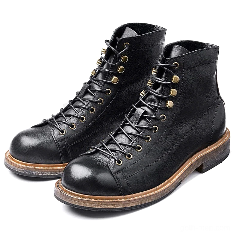 Pair of men's gothic lace-up ankle boots in black and brown with brass lace eyelets, flat lay front view