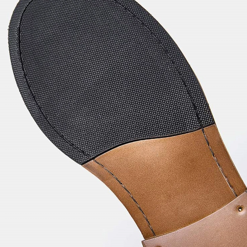 Rubber sole close-up of men's gothic ankle boots showing stitched construction and leather heel panel reinforcement