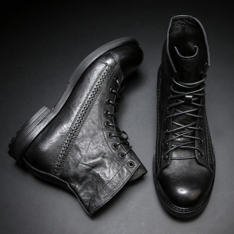Pair of black gothic leather ankle boots flat lay with stitched decorative details