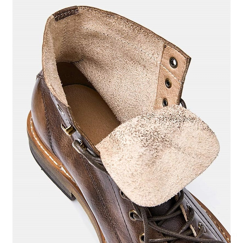 Interior close-up of gothic lace-up ankle boots showing furry lining and genuine leather upper construction