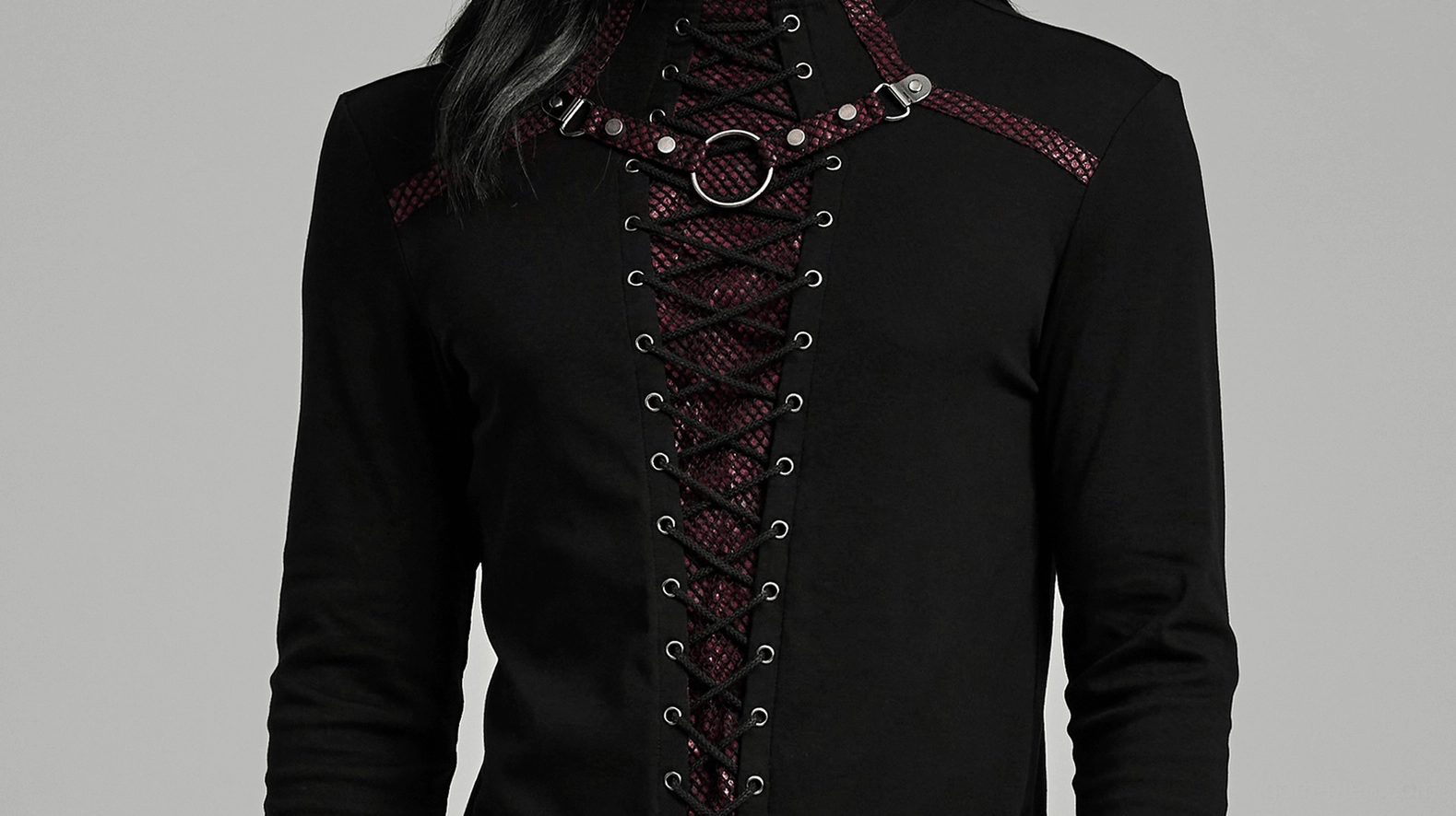 Cropped front close-up of men's gothic top showing lace-up front closure with red mesh underlayer and metal eyelet fasteners