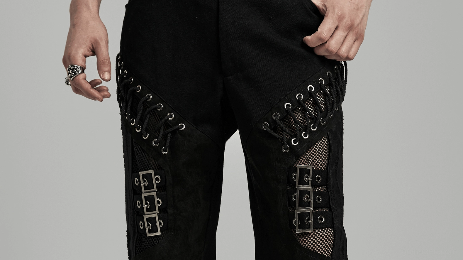 Punk gothic black pants worn by model showing thigh lace buckle details close-up view