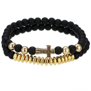 Gold-tone gothic lava stone beaded bracelet with cross charm on white background