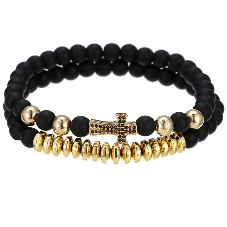 Gold-tone gothic lava stone beaded bracelet with cross charm on white background