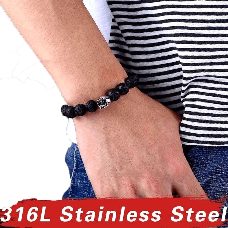 Unisex gothic skull lava stone bracelet worn on male wrist with striped shirt styling