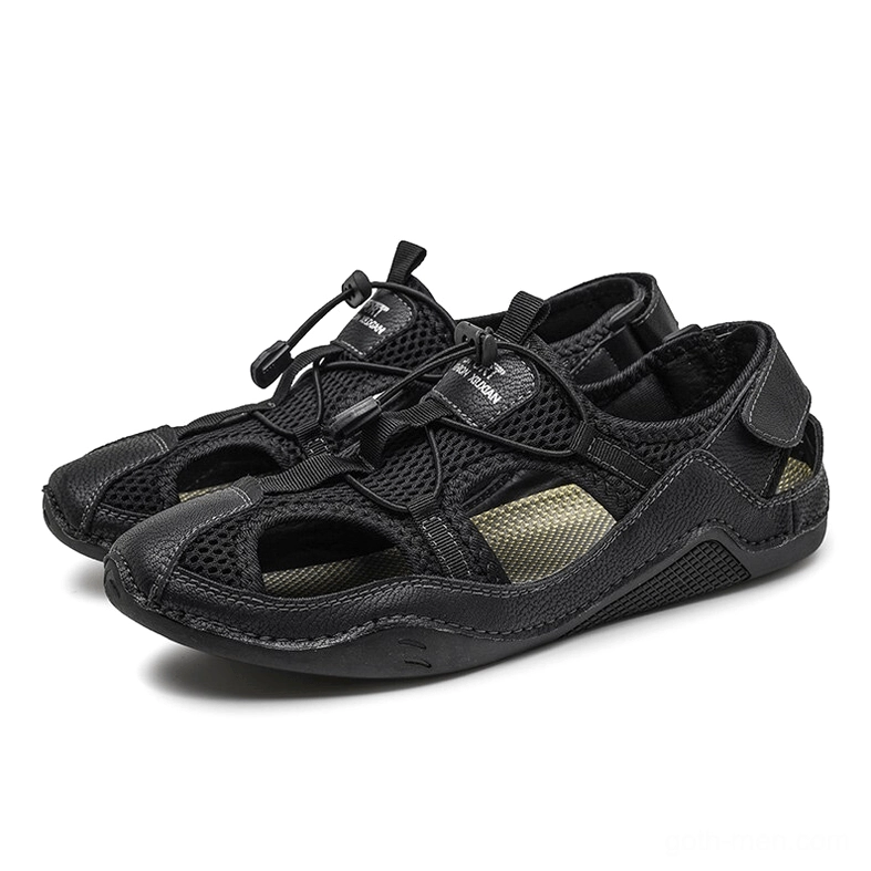 Men's gothic leather ankle-wrap sandals all-black pair front three-quarter view with toggle drawstring closure