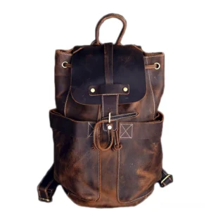 Dark brown distressed genuine leather gothic travel backpack front view with brass drawstring closure and metal hardware details