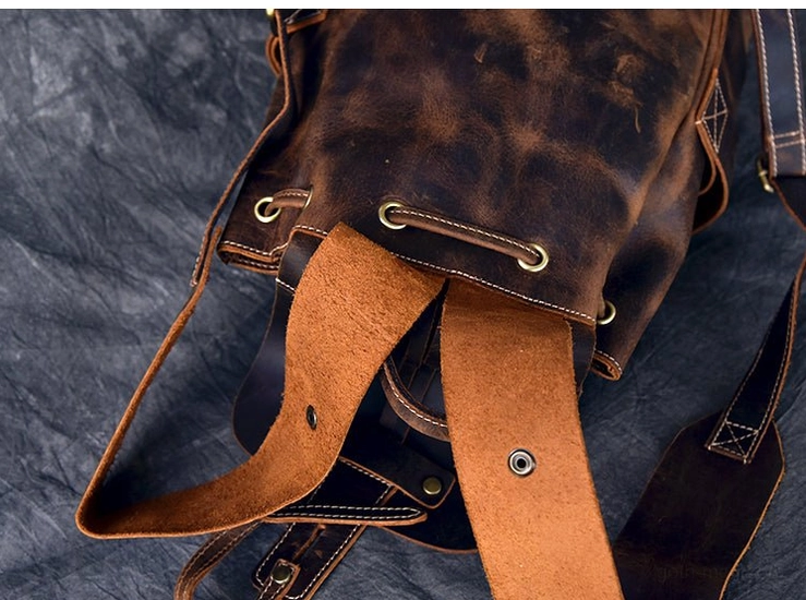 Dark brown distressed cow leather gothic backpack showing natural patina and aging aesthetic characteristic