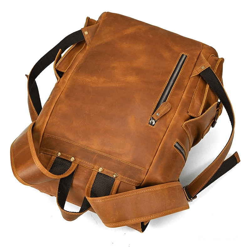 Dark aesthetic leather gothic backpack showing flap cover closure mechanism and fasteners